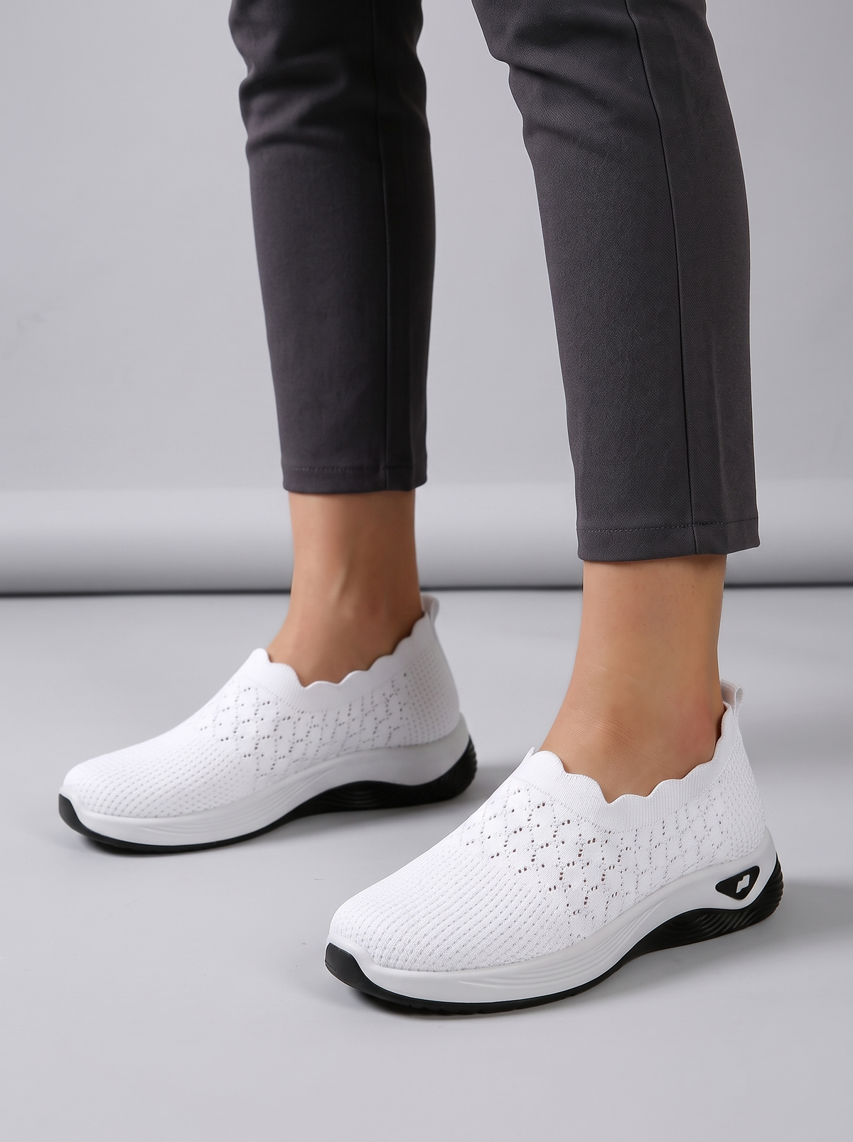 Remi Women's Ultra-Light Slip-On in white, worn on the foot