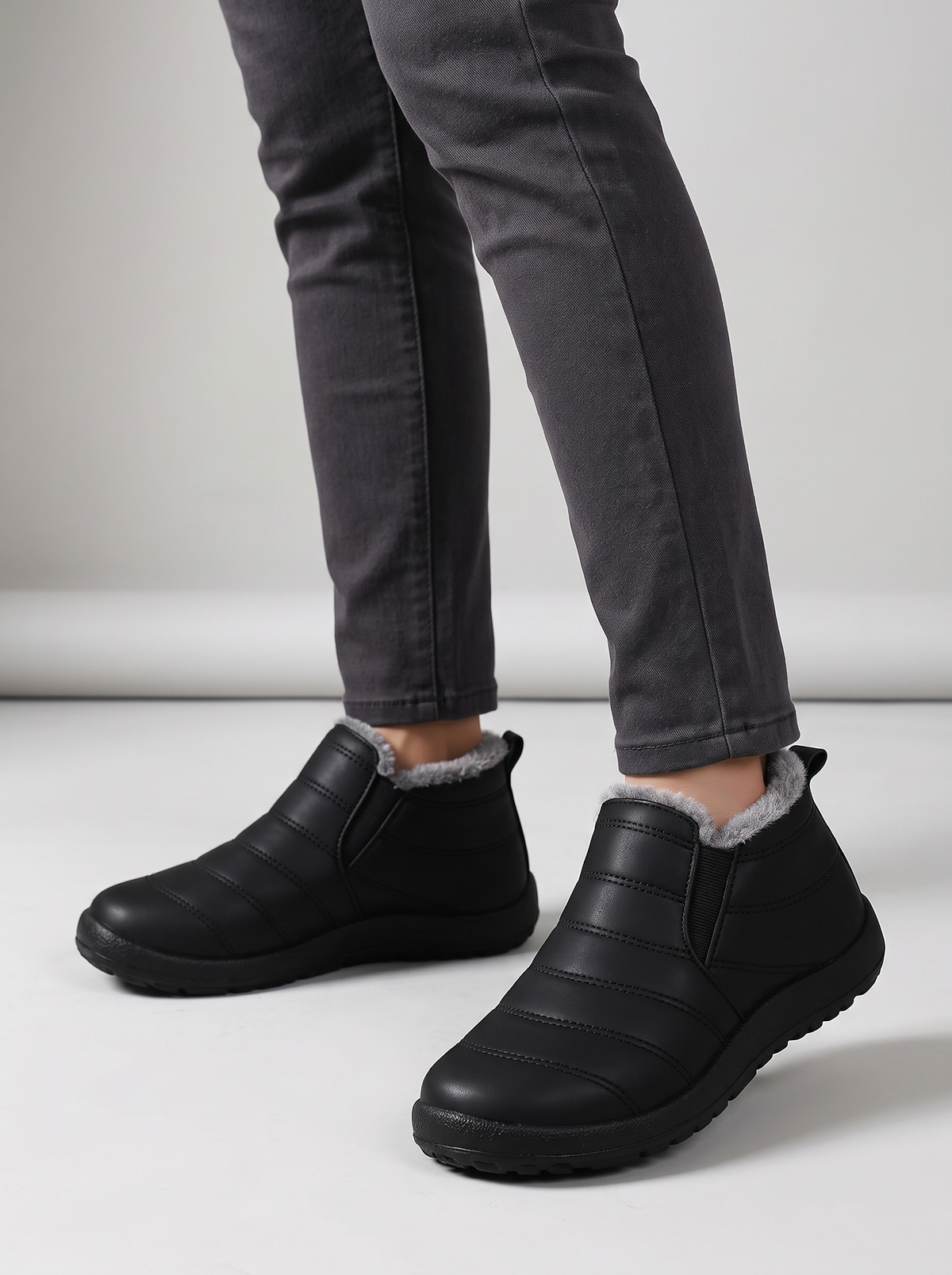 Holly Women's Cozy Slip-On in black, worn on the foot