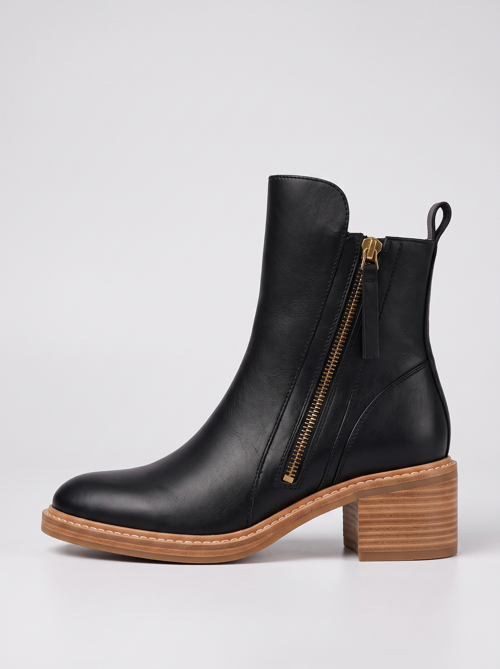 Erica black leather ankle boot side profile showing the gold side zipper