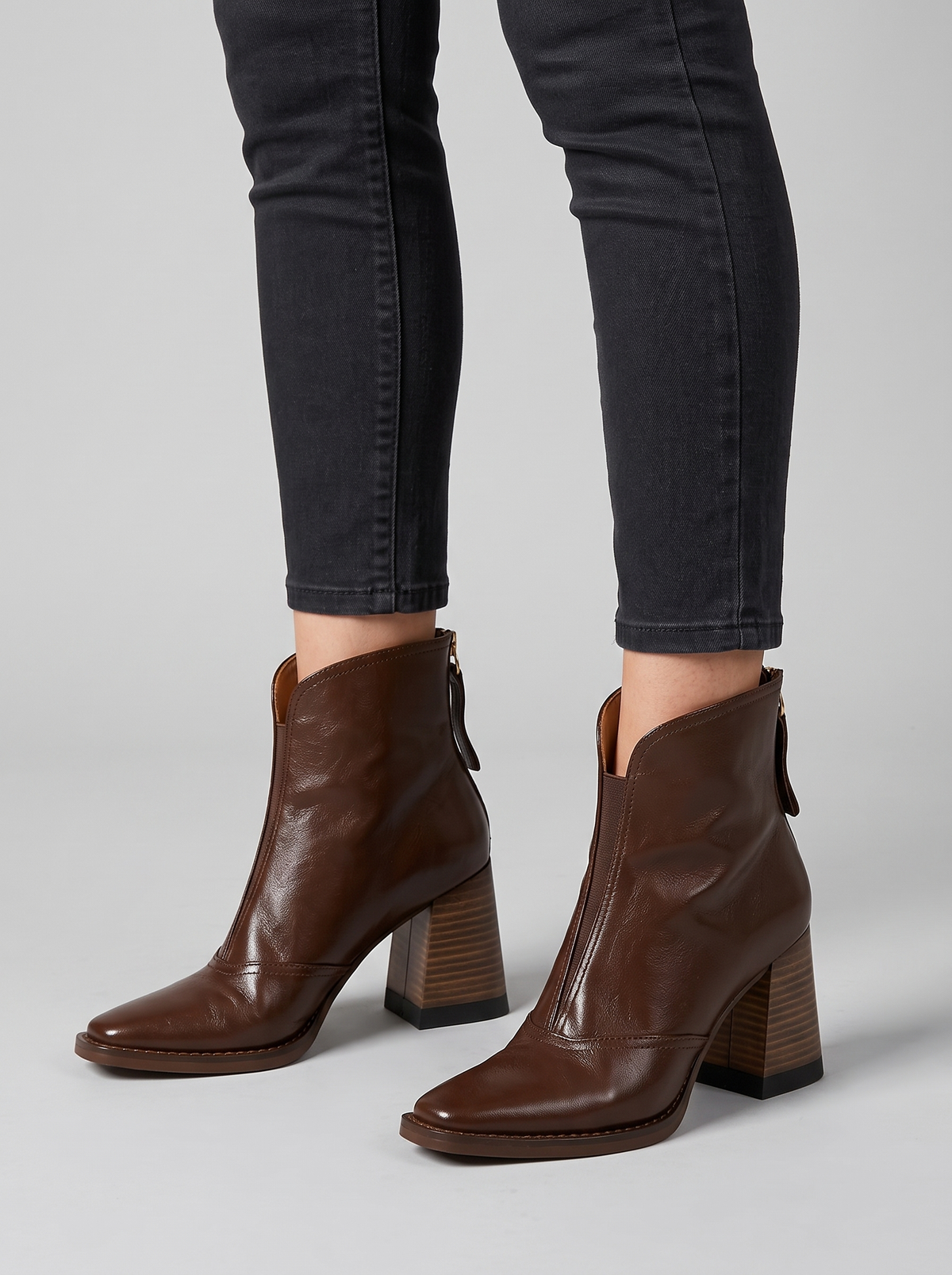 Rochelle brown leather ankle boots worn with slim dark trousers